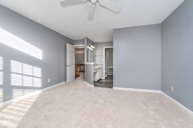 interior space with ceiling fan and light colored carpet