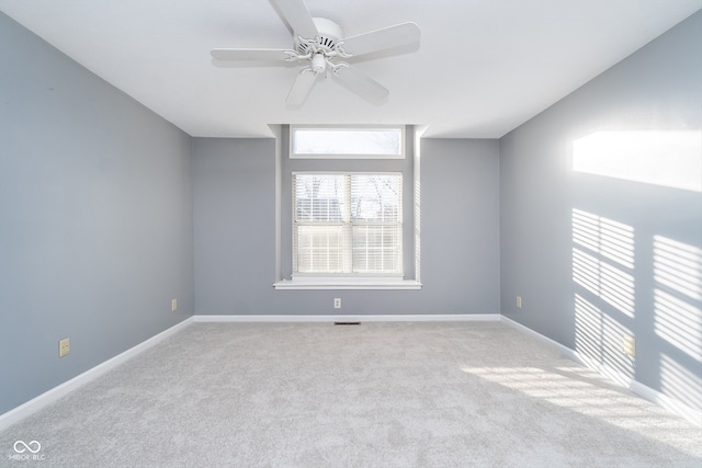 carpeted empty room featuring ceiling fan