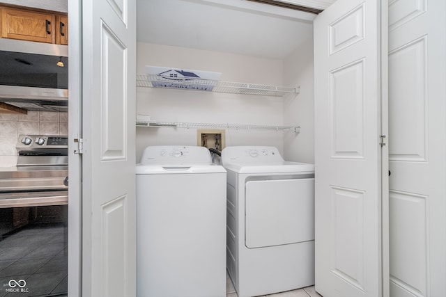 washroom featuring light tile patterned floors and separate washer and dryer