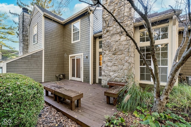 rear view of house featuring a wooden deck