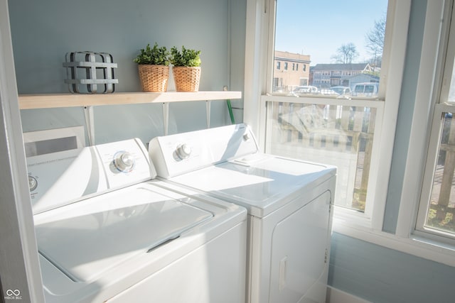 washroom with washing machine and clothes dryer