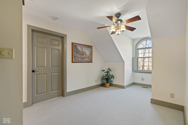 bonus room featuring ceiling fan, lofted ceiling, and light carpet