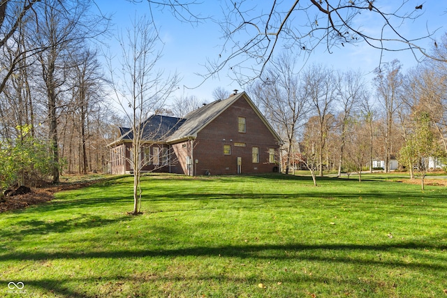 view of side of property with a lawn