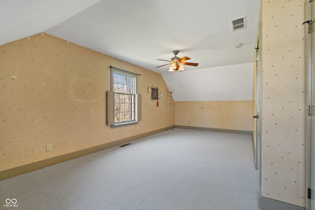 bonus room with carpet floors, ceiling fan, and lofted ceiling