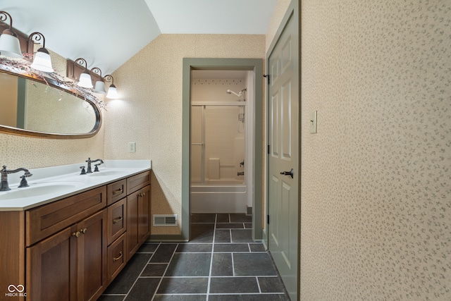 bathroom with combined bath / shower with glass door, vanity, tile patterned floors, and lofted ceiling