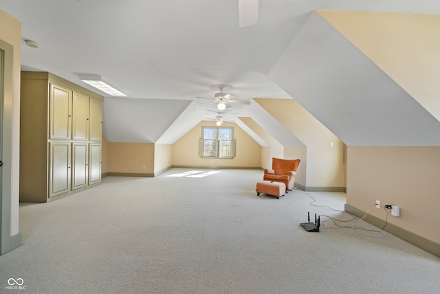 additional living space with ceiling fan, light carpet, and vaulted ceiling