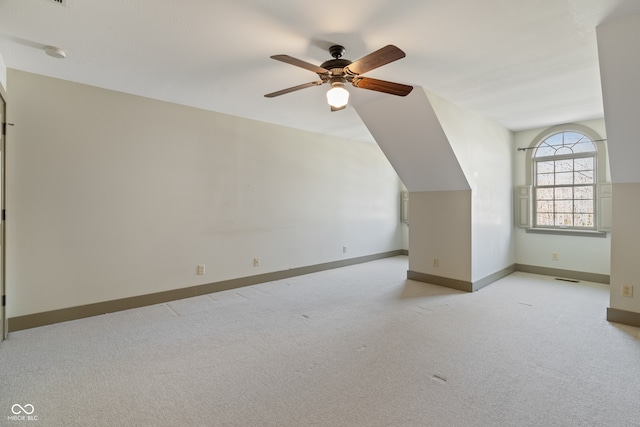 bonus room with light colored carpet, vaulted ceiling, and ceiling fan