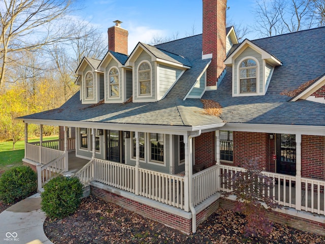 rear view of house featuring covered porch