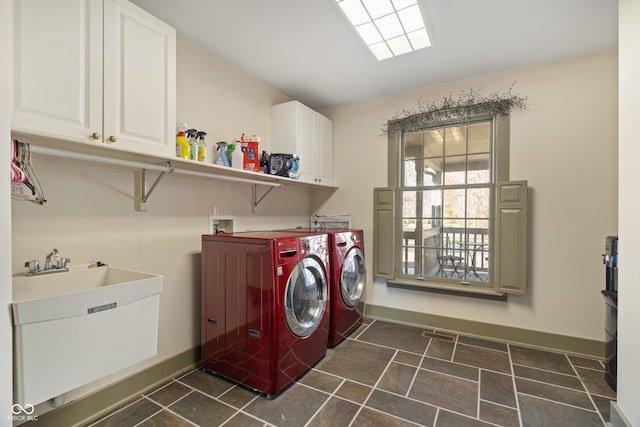 clothes washing area featuring cabinets, independent washer and dryer, and sink