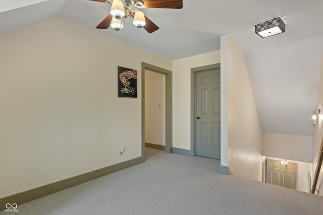 interior space with ceiling fan, light carpet, and lofted ceiling