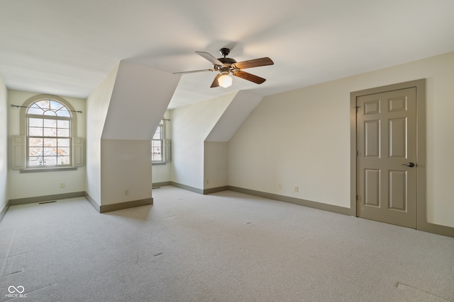 bonus room with light carpet, ceiling fan, and lofted ceiling