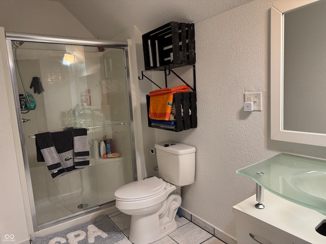 bathroom with tile patterned flooring, a shower with door, vanity, and toilet