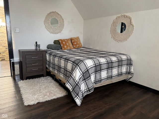 bedroom featuring hardwood / wood-style flooring and vaulted ceiling