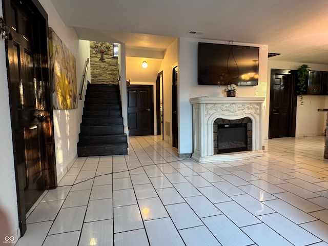 unfurnished living room with light tile patterned floors