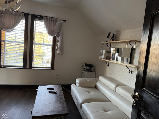 living room with dark hardwood / wood-style flooring and vaulted ceiling