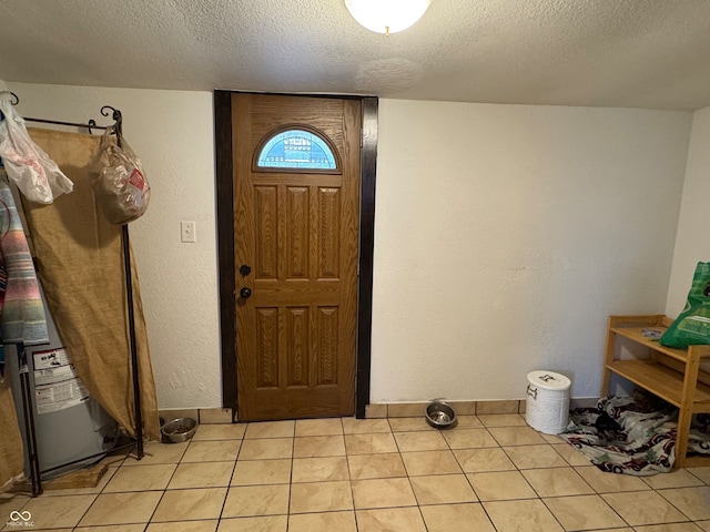 foyer with light tile patterned flooring and a textured ceiling