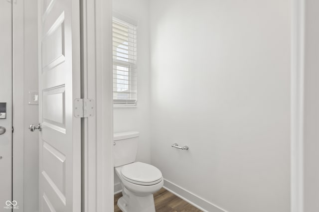 bathroom featuring hardwood / wood-style floors and toilet