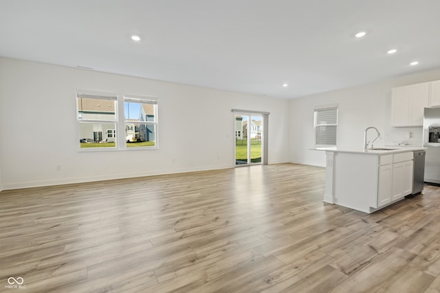 interior space with plenty of natural light, light hardwood / wood-style floors, and sink