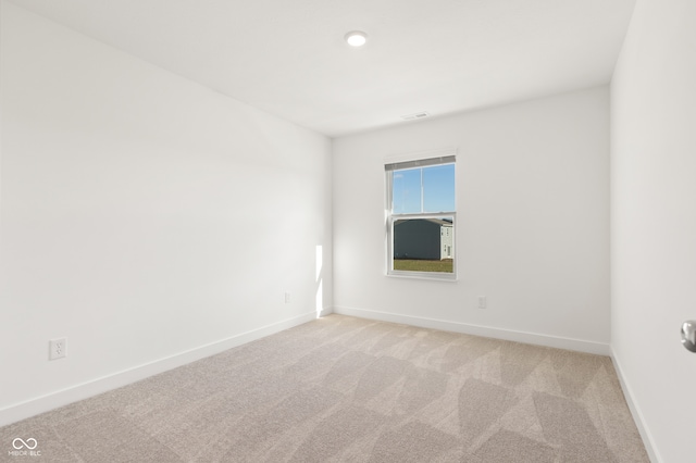 empty room with light colored carpet