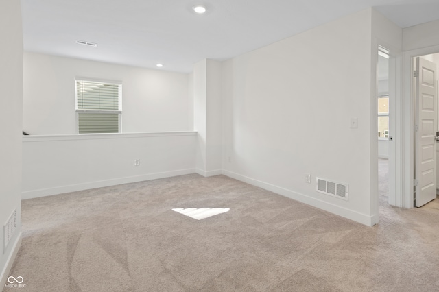 empty room featuring light carpet