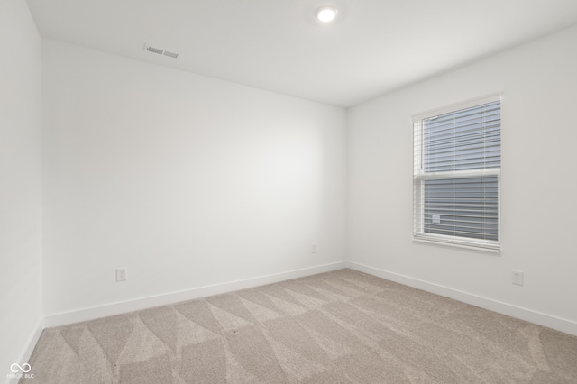 empty room featuring light carpet