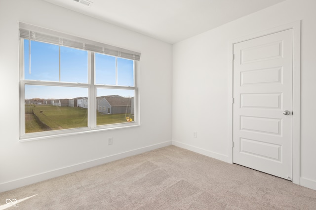 empty room featuring light carpet