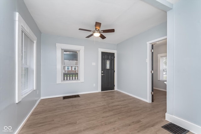 foyer entrance with hardwood / wood-style floors and ceiling fan