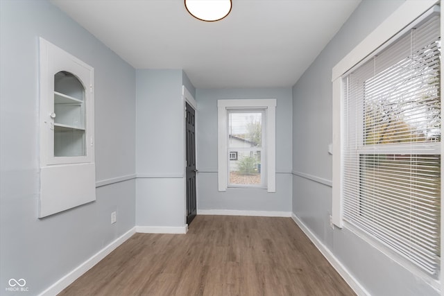 hallway with hardwood / wood-style floors