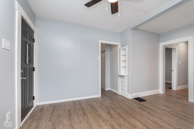 unfurnished bedroom featuring hardwood / wood-style flooring and ceiling fan