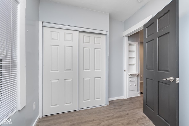 bedroom featuring hardwood / wood-style floors and a closet