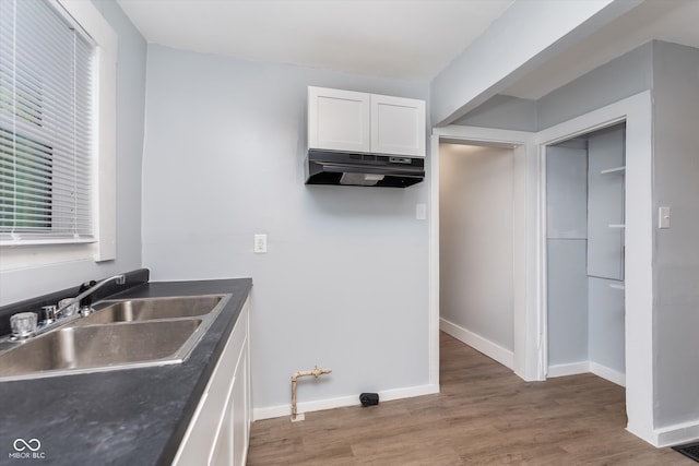 kitchen with sink, white cabinets, and dark hardwood / wood-style floors