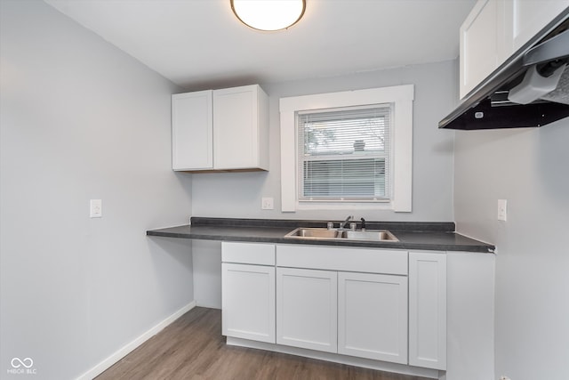 kitchen featuring white cabinets, sink, and dark hardwood / wood-style floors