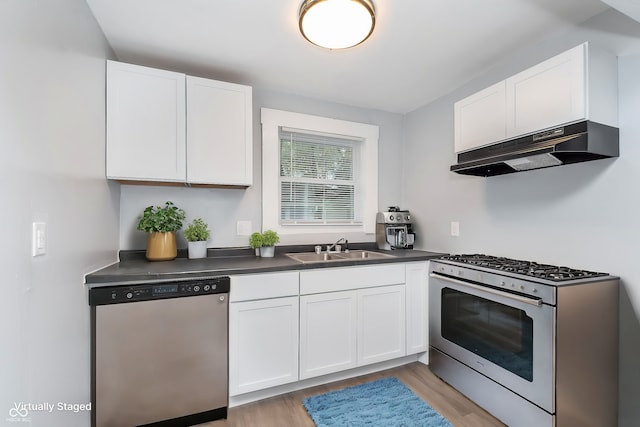 kitchen featuring white cabinetry, sink, light hardwood / wood-style flooring, and appliances with stainless steel finishes