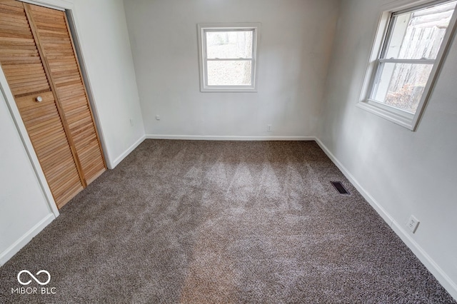 unfurnished bedroom with carpet and a closet