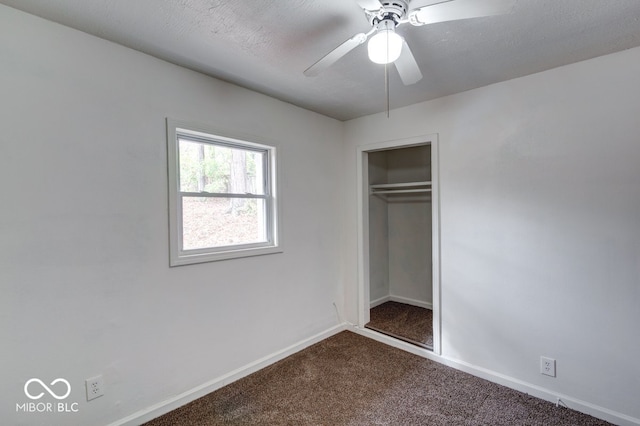 unfurnished bedroom with a closet, a textured ceiling, ceiling fan, and carpet flooring