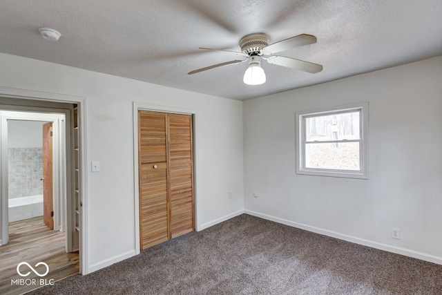 unfurnished bedroom with light carpet, a textured ceiling, a closet, and ceiling fan