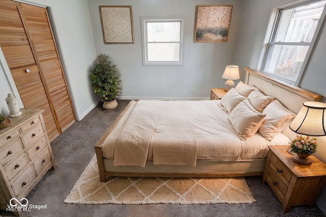 bedroom featuring a closet and dark colored carpet