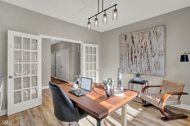 office with french doors and light wood-type flooring