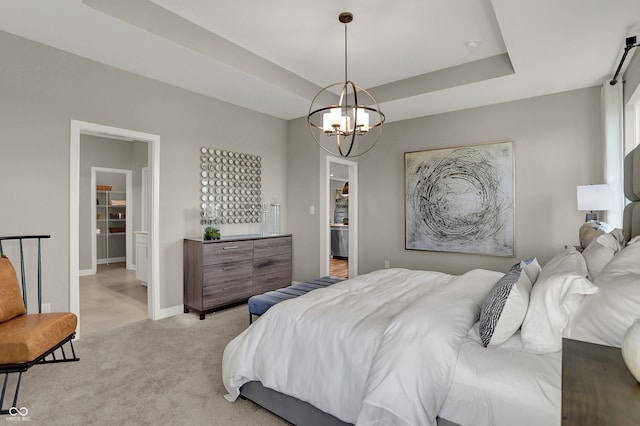 carpeted bedroom featuring a tray ceiling and an inviting chandelier