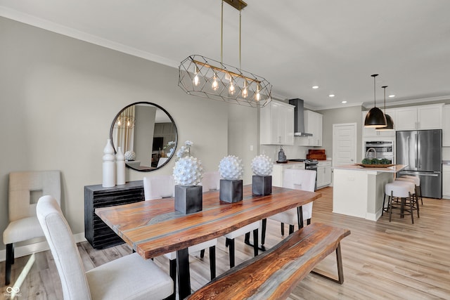 dining space featuring light hardwood / wood-style flooring and ornamental molding