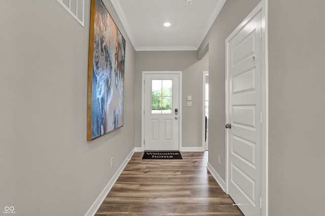 doorway to outside featuring crown molding and hardwood / wood-style flooring