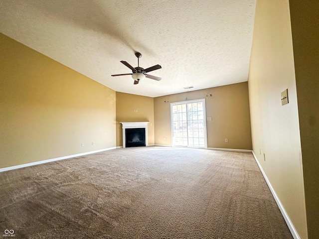 unfurnished living room with ceiling fan, carpet flooring, and a textured ceiling