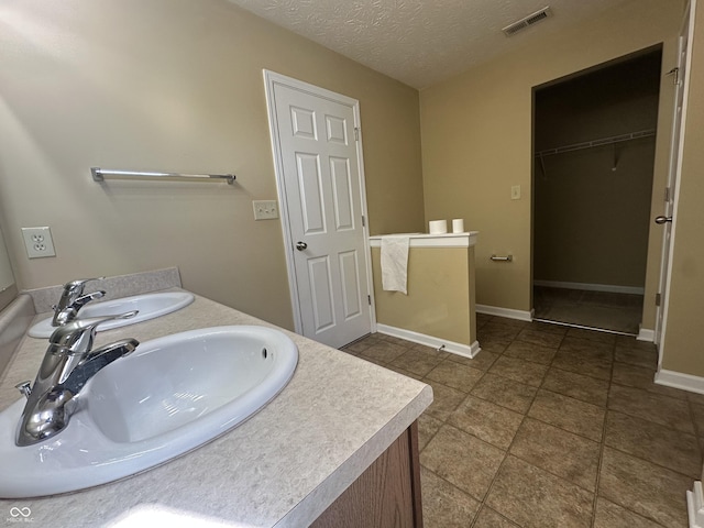 bathroom featuring sink and a textured ceiling