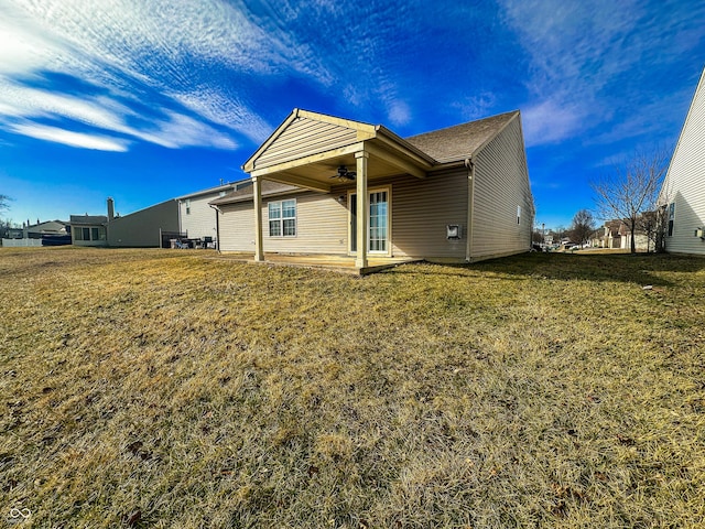 back of house with a yard, a patio, and ceiling fan