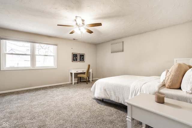 carpeted bedroom featuring baseboards and ceiling fan