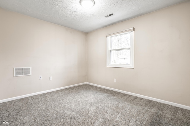 empty room with visible vents, baseboards, and carpet flooring