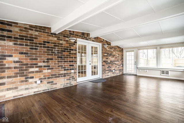 interior space featuring lofted ceiling with beams, french doors, and a wall mounted AC