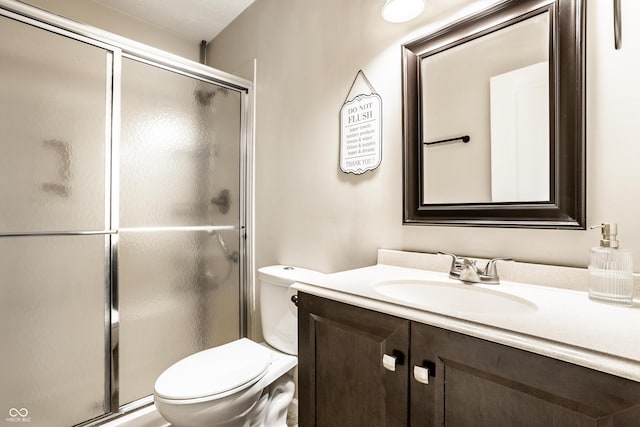 full bath featuring vanity, toilet, and a stall shower