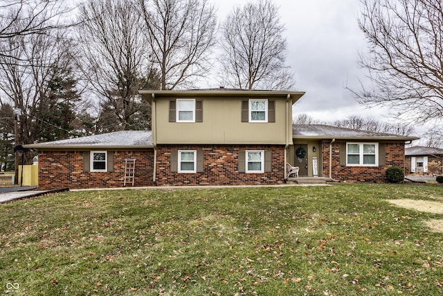 split level home featuring brick siding and a front lawn