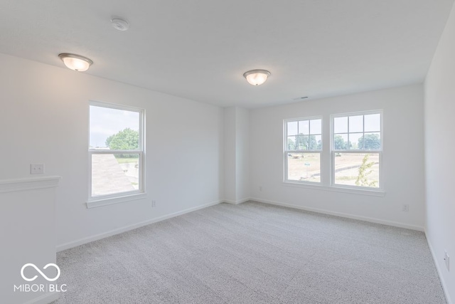 carpeted empty room with a wealth of natural light